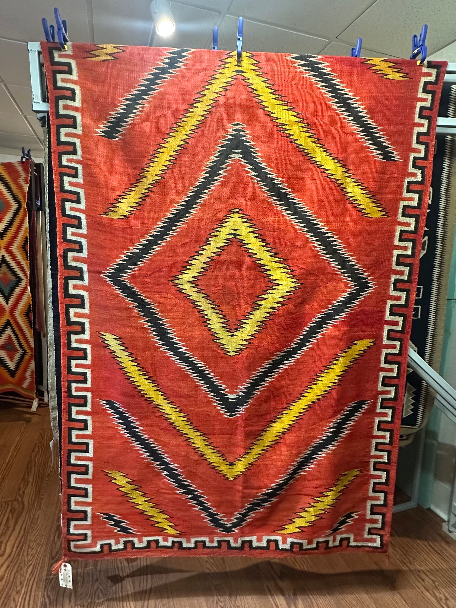 navajo antique transitional blanket with Red patterned rug with yellow and black designs 